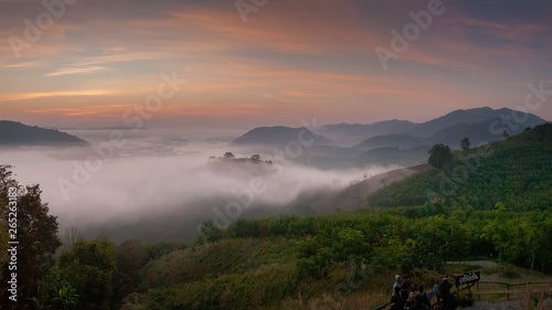 sunrise at Phu Huay Esan View Point, view of the hill around with sea of mist above Mekong river with soft red light in the sky background, Ban Muang, Sang Khom District, Nong Khai, Thailand.