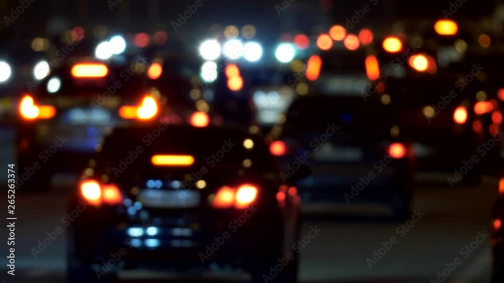 Rush hour traffic jam on the road in the evening. Abstract unfocused view of car lights are seen. UHD