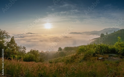 sunrise at Phu Huay Esan View Point, view of the hills around with sea of fog above Mekong river with blue sky background, Ban Muang, Sang Khom District, Nong Khai, Thailand.