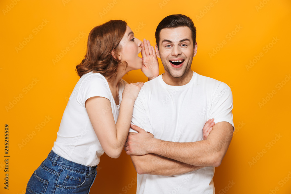 Fototapeta premium Excited beautiful couple wearing white t-shirts standing