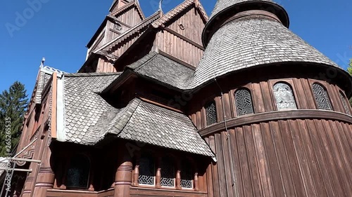  Downview the back tower of the stave church, a Norwegian style wooden church in Hahnenklee in the Harz Mountains, with a swing from the top of the tower to the ground. photo