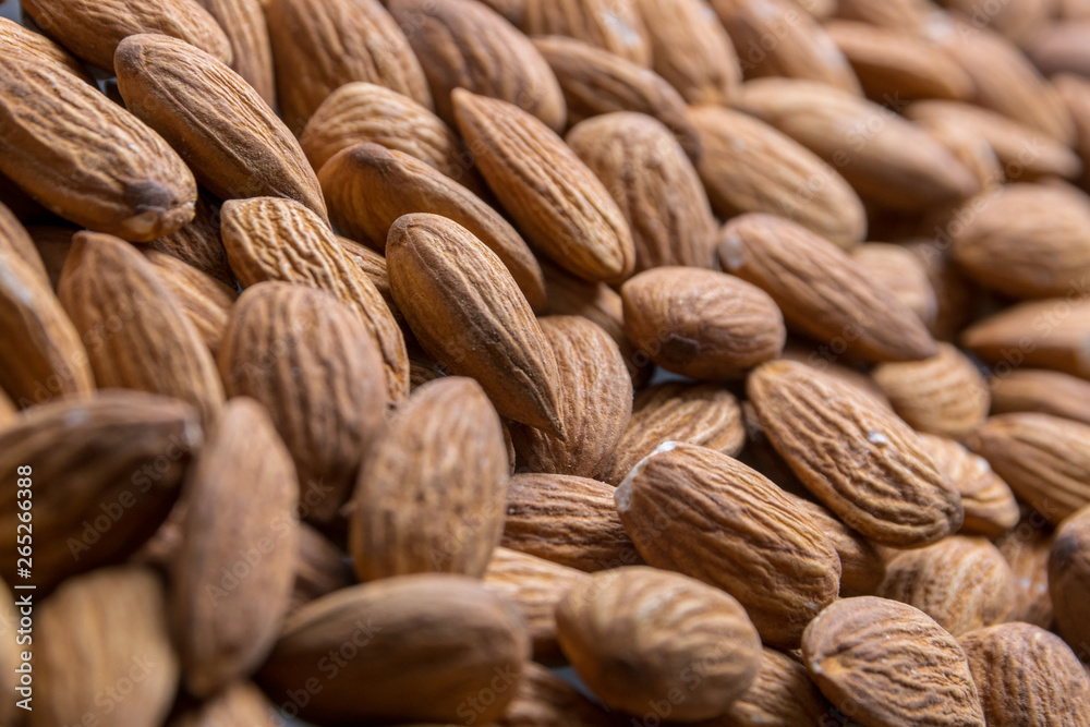 Fototapeta premium Almond nuts close up. Healthy fitness super food.