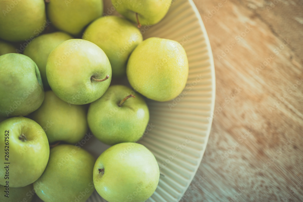 Fresh green apples in bowl on wooden background Fresh green apples in bowl on wooden background