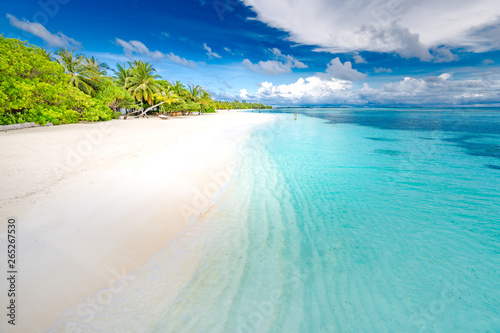 Fototapeta Naklejka Na Ścianę i Meble -  Summer travel destination. Design of summer vacation holiday concept. Perfect tranquil beach scene, soft sunlight and white sand and blue endless sea as tropical landscape