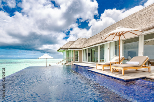 Luxury swimming pool near beach front, view from water villa in Maldives