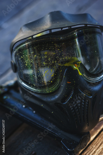 Special protective mask for playing paintball with traces and spot of hit of a ball with paint.  © Evgenii Starkov