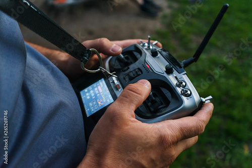 man holds a remote control during the flight control of a sports drones