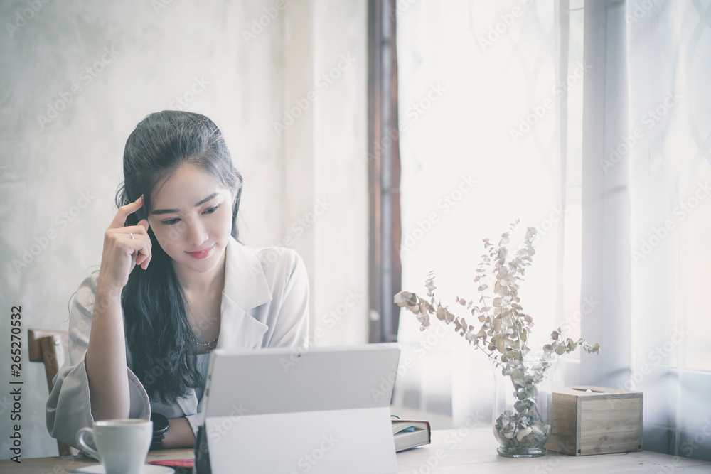 Confident happiness young woman working on laptop or notebook in her office. Confident happiness young woman working on laptop or notebook in her office.