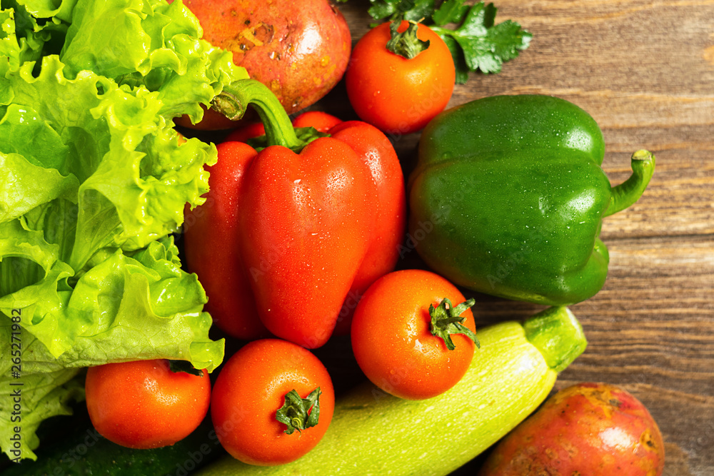 Fresh vegetables bunch greens on wooden background. Vegetarianism is a healthy lifestyle. Flat layout. View from above.