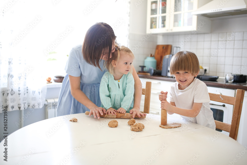 Children brother and sister make cakes from dough Children brother and sister make cakes from dough