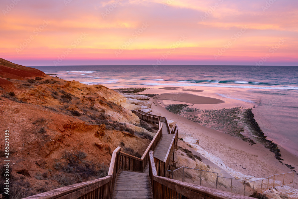 A beautiful sunrise at southport port noarlunga south australia overlooking the wooden staircase ocean and cliffs on the 30th April 2019 - obrazy, fototapety, plakaty 