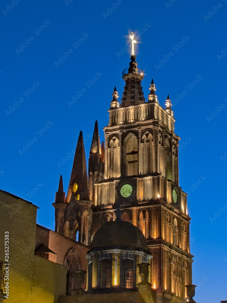 Side view of La Parroquia de San Miguel Arcangel and clock tower lit in the Blue Hour