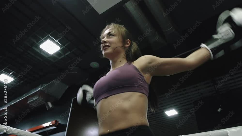Woman is warming taking rest before doing kickboxing training with her coach. Woman is warming taking rest before doing kickboxing training with her coach.