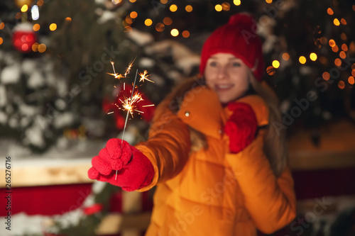 Young woman holding sparkle...
