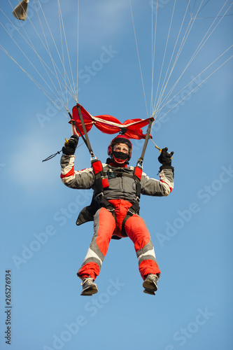 Young skydiver lands with a parachute close-up.