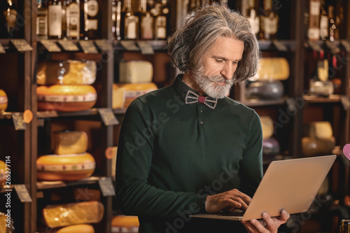 Business owner with laptop ...