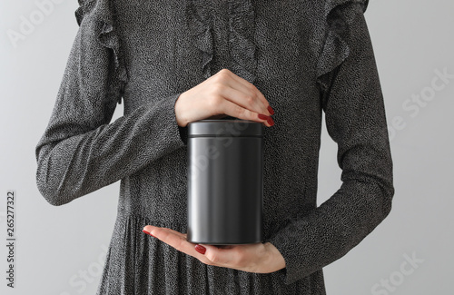 Woman with mortuary urn on light background photo
