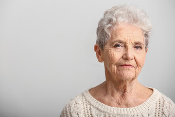 Portrait of senior woman on white background