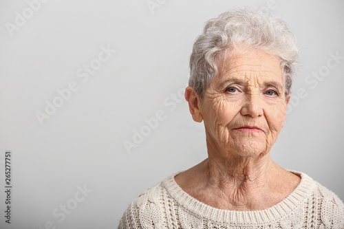Portrait of senior woman on white background