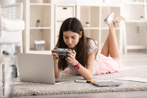 Young girl with photo camer...