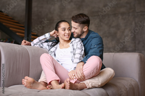 Happy young couple spending time at home