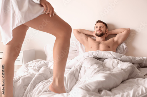 Husband waiting for his sexy wife in bed