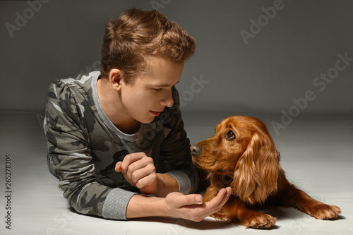 Teenage boy with cute dog o...