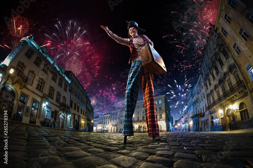 Night street circus performance whit clown. Festival city background. fireworks and Celebration atmosphere. Wide engle photo photo