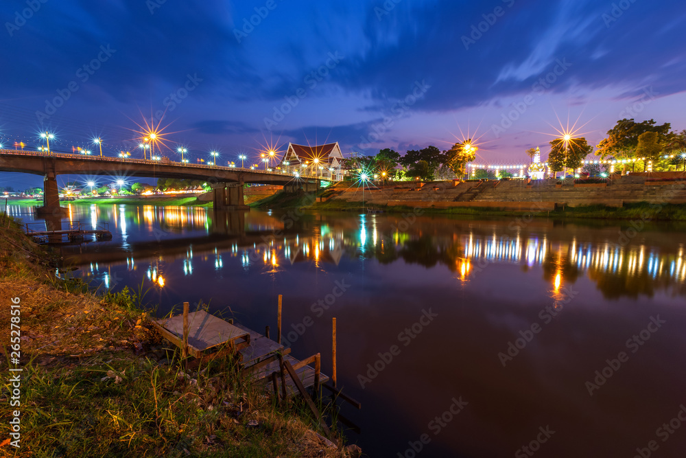 Beautiful light on the Nan River at night on the bridge (Naresuan Bridge) in Phitsanulok City,Thailand.
