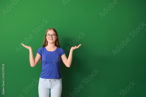 Cute teenage girl on color background