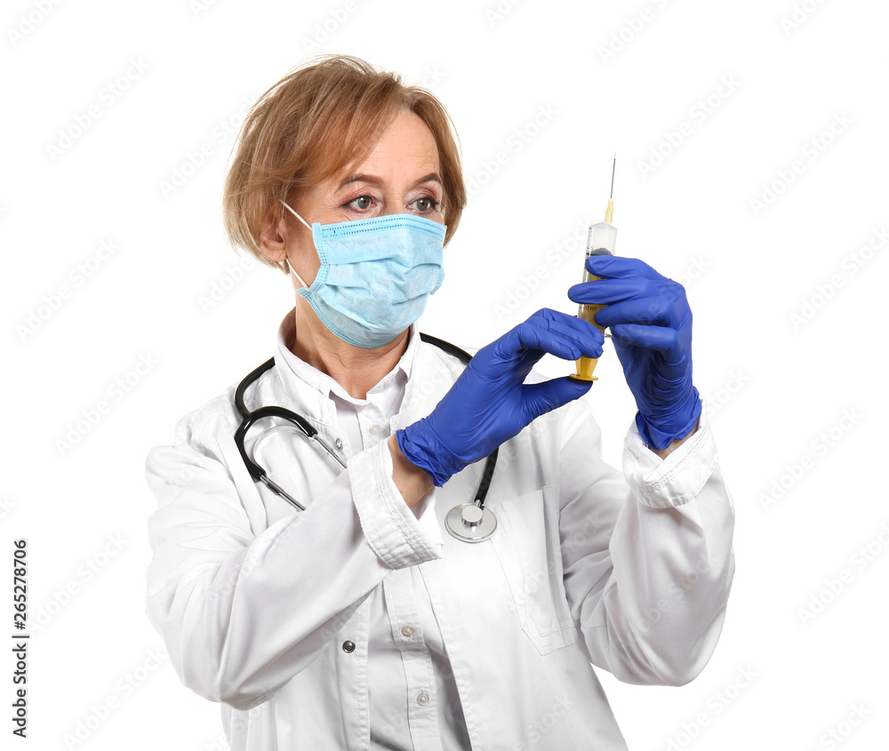 Beautiful female doctor with syringe on white background