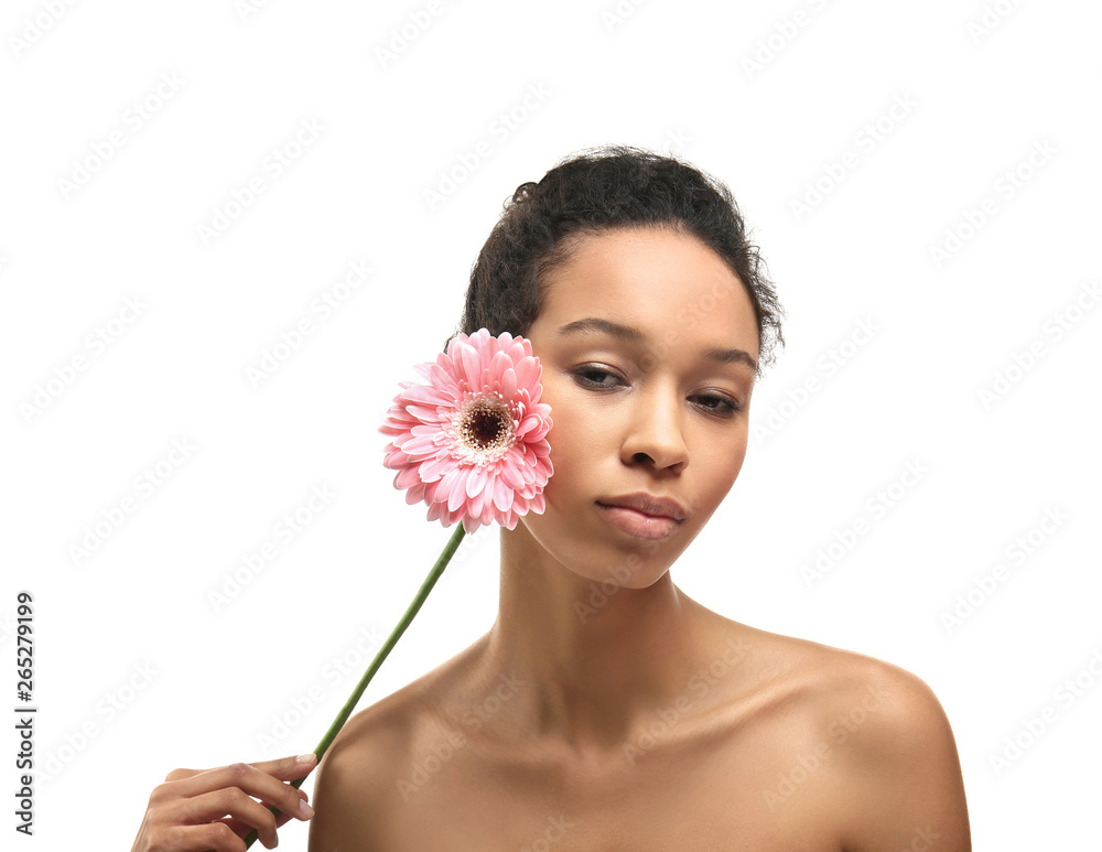 Young African-American woman with flower on white background Young African-American woman with flower on white background