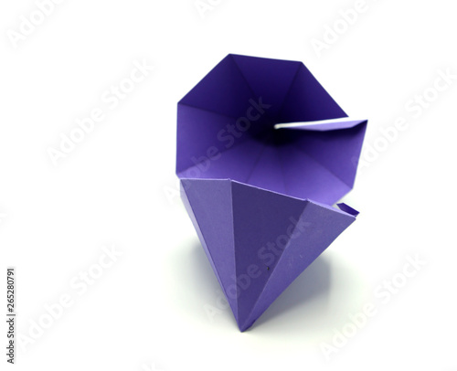 Geometric shape cut out of purple paper and photographed from above on white background. Geometry net of Octagonal Dipyramid. 2D shape that can be folded to form a 3D shape or a solid. © fotosen55