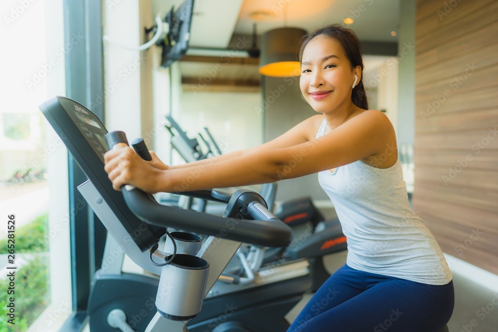 Portrait beautiful young sport asian woman exercise and work out with fitness equipment in gym