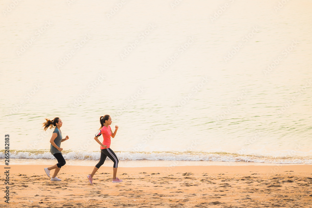 Portrait beautiful young sport asian woman running and exercise on the beach near sea and ocean at sunrise or sunset time Portrait beautiful young sport asian woman running and exercise on the beach near sea and ocean at sunrise or sunset time