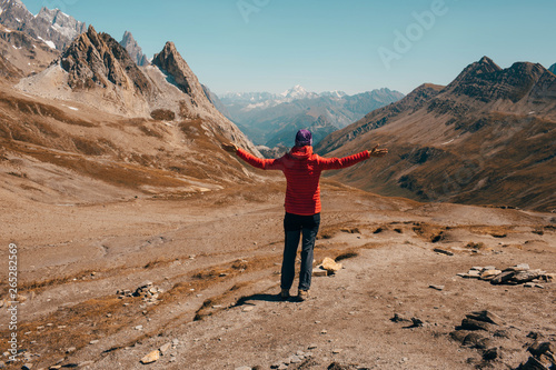 Εκτύπωση καμβά tourist with raised hands standing at mountain pass Col de la Seigne