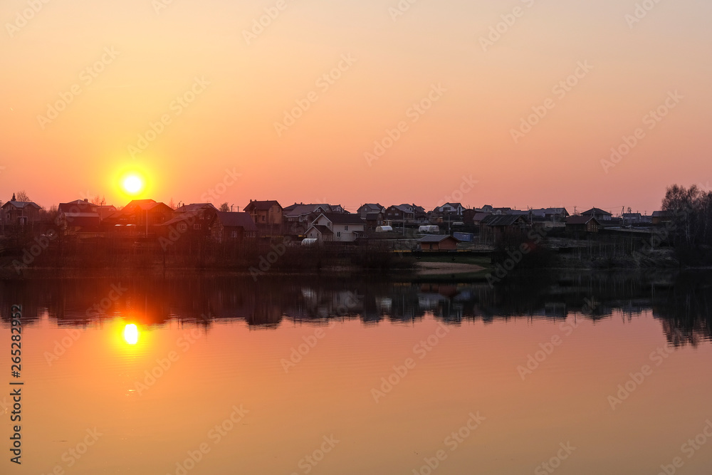 Landscape with the image of spring lake at sunset