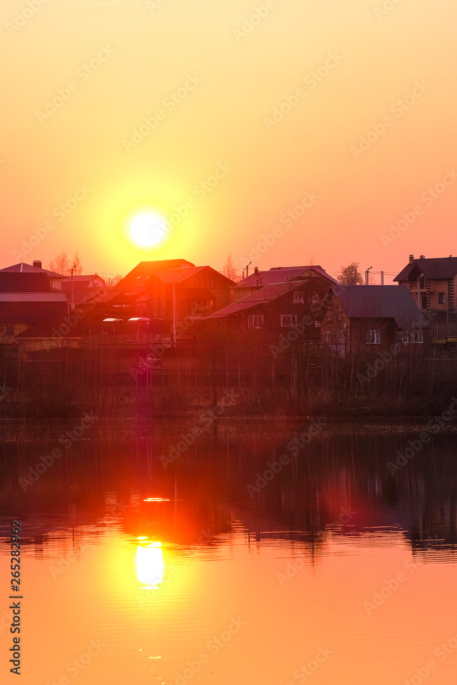 Fototapeta premium Landscape with the image of spring lake at sunset