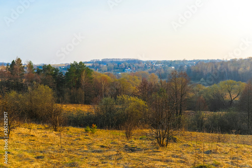 Landscape with the image of spring countryside in Tula region in Russia at sunset