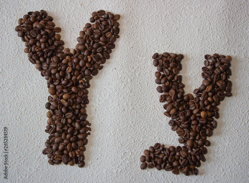 Image of roasted coffee beans shaped alphabet on a white background