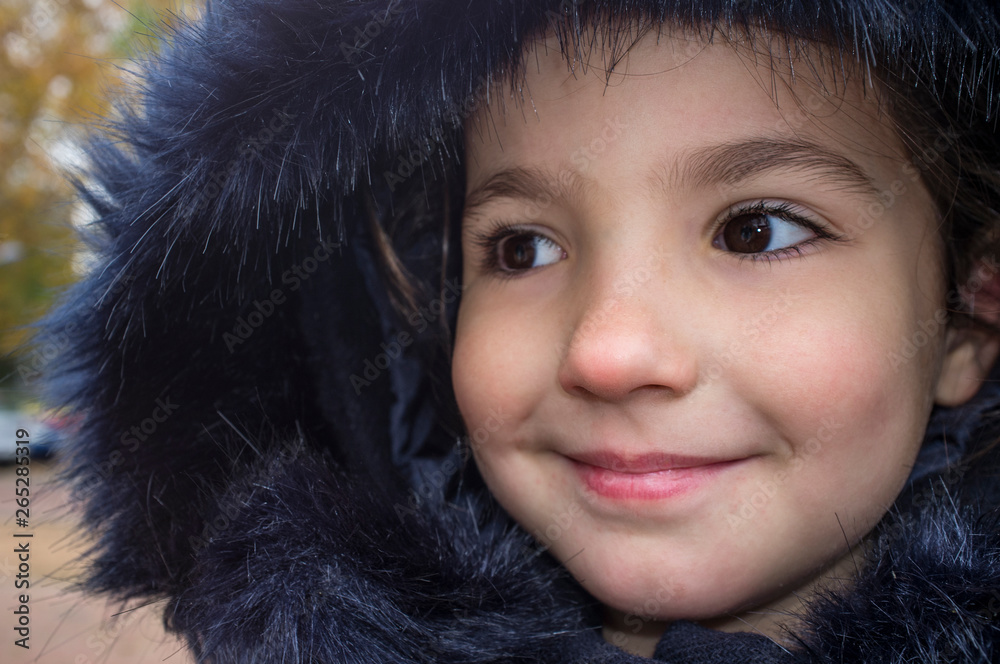 Little girl wearing dark blue winter coat with faux fur hood Little girl wearing dark blue winter coat with faux fur hood