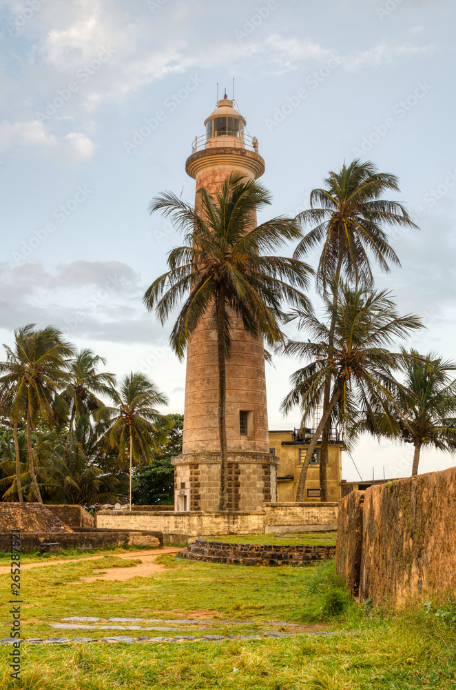 Galle Lighthouse, Sri Lanka behind the palms trees