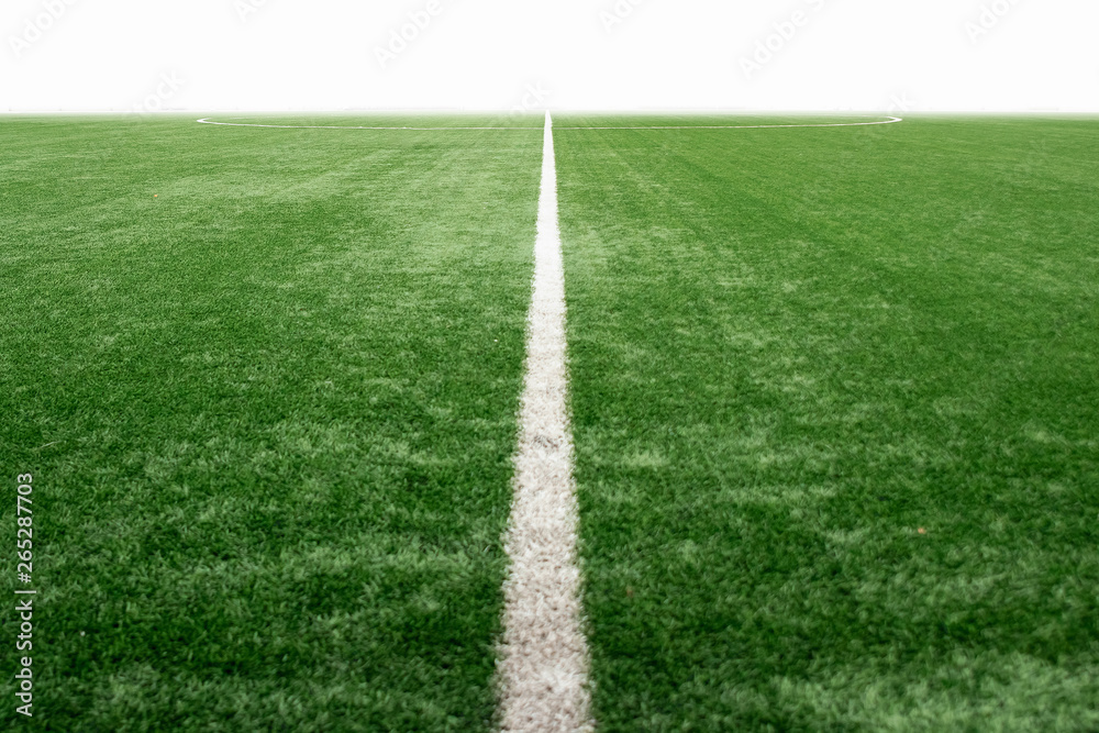 Obraz premium Green sports field with artificial grass, football field perspective.