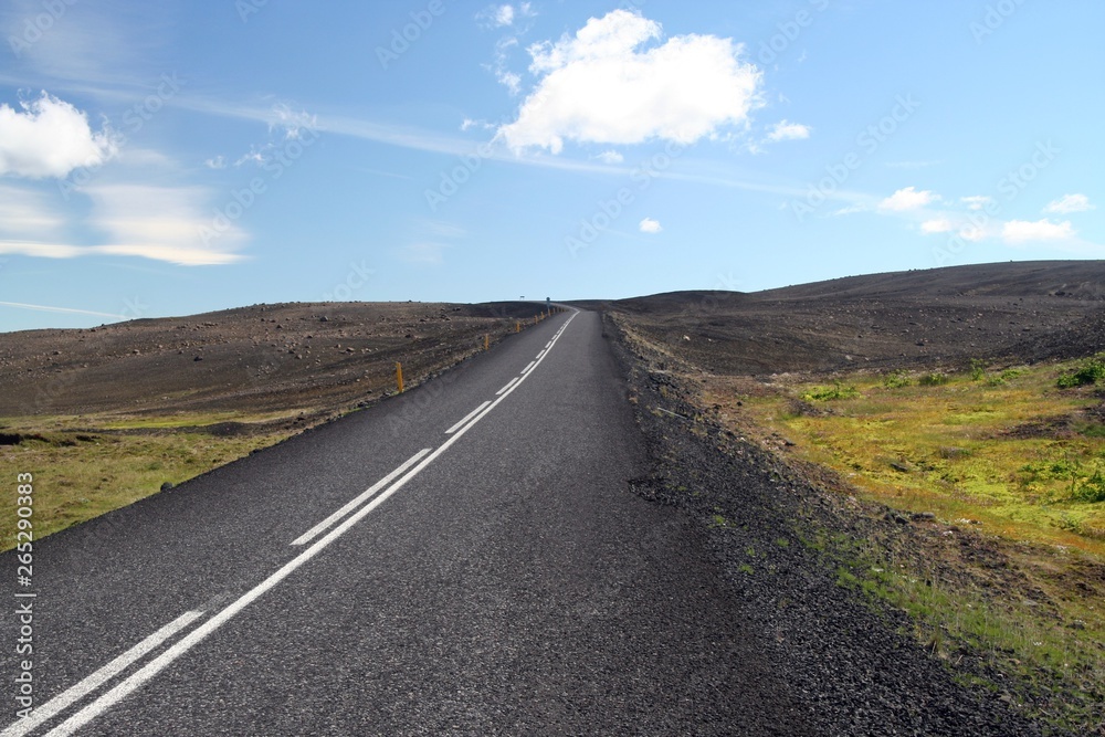 Endless straight asphalt road in barren wide landscape Endless straight asphalt road in barren wide landscape