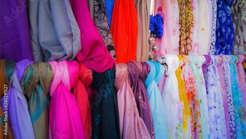 A variety of colorful fashion scarves for sale at a market © Andrea Kuipers