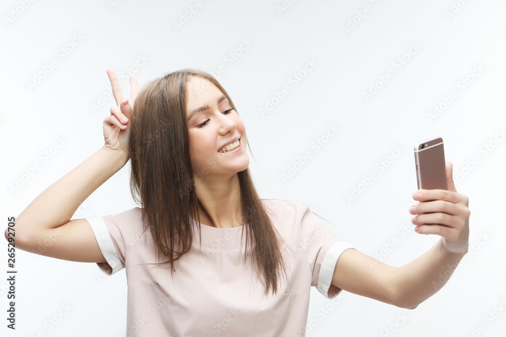 happy smiling young woman wearing taking selfie with smartphone happy smiling young woman wearing taking selfie with smartphone
