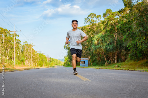 Fat man jogger athlete training and doing workout outdoors on street road