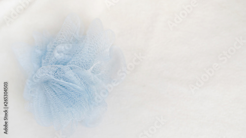 Bath sponge on white background with copy space. sponge on towel , spa concept place for text