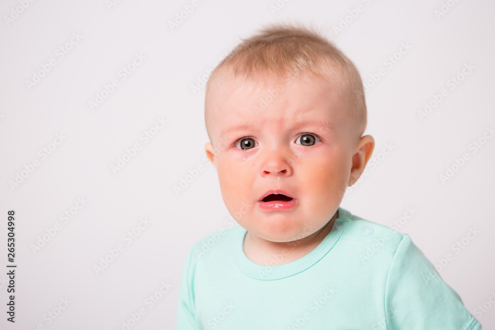 baby boy 6 months crying on white background 