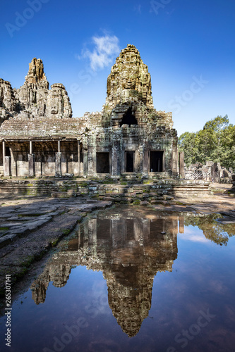 Relections of the towers and beautiful face sculptures at the famous Bayon temple in the Angkor Thom temple complex  Siem Reap  Cambodia